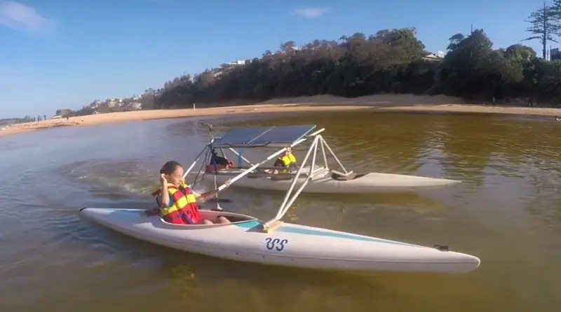 two children out sailing in a solar powered catamaran